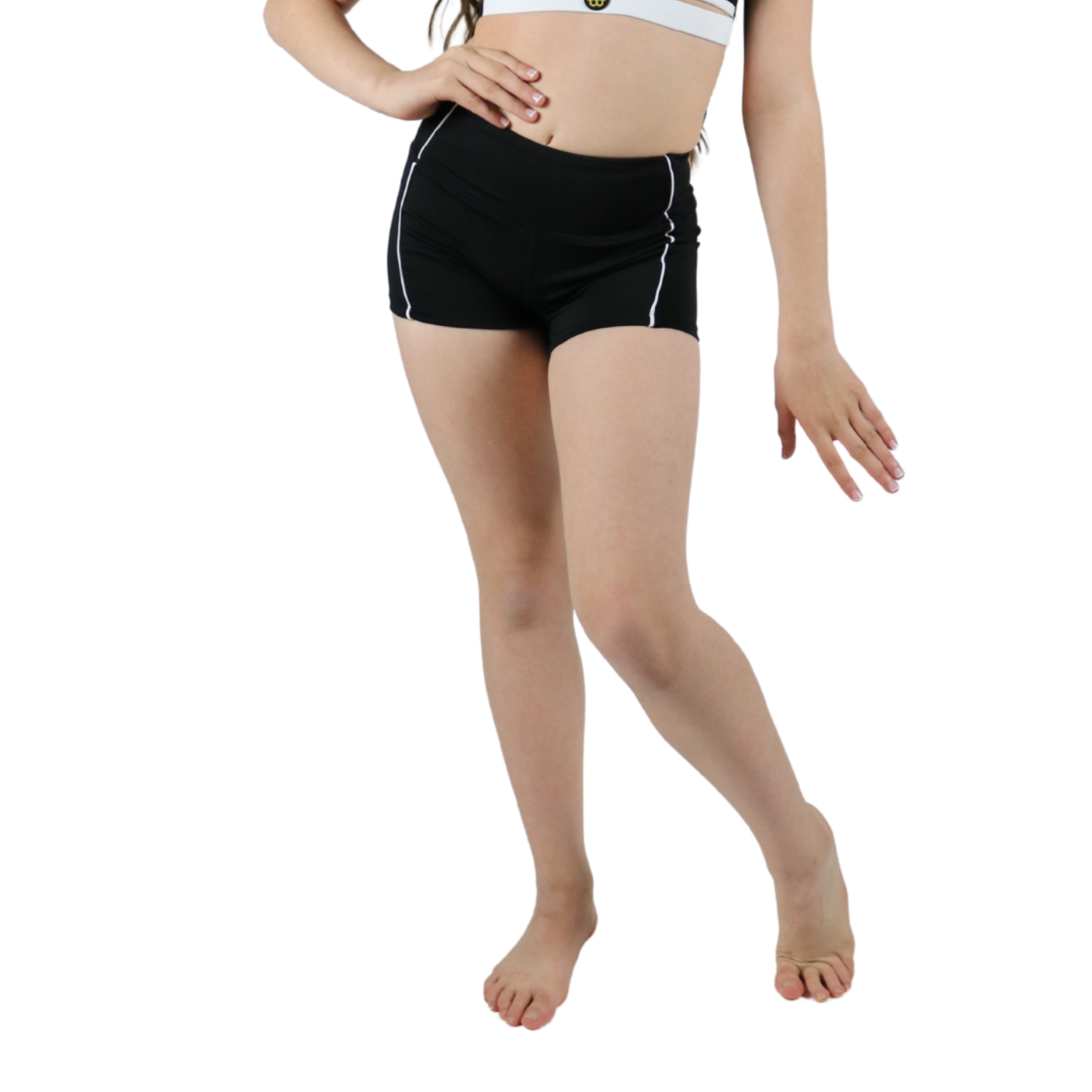 Young girl wearing a black and white sports outfit on a white background