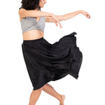 Bodywrappers 24" Circle Skirt in Black, lifestyle view showing matte polyester fabric and flowing hem in motion