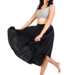 Bodywrappers 24" Circle Skirt in Black, lifestyle view showing matte polyester fabric spread into a wide flare
