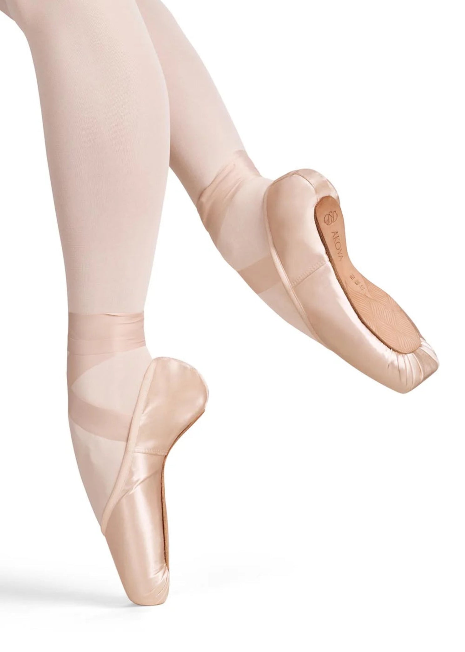 RP Collection Akoya Pointe Shoe in Pink, lifestyle view showing outsole and platform with satin upper en pointe