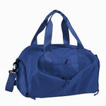 Danznmotion all-in-one dance duffel in Royal, angled front view showing structured barrel shape, front zip pocket, dual top handles, and adjustable shoulder strap