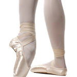 R Class Arpeggia Pointe Shoe Vamp 3 in Pink, lifestyle view showing satin upper with ribbons and elastic en pointe