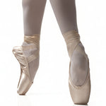 R Class Arpeggia Pointe Shoe Vamp 3 in Pink, lifestyle view showing vamp and platform with ribbon wrap en pointe