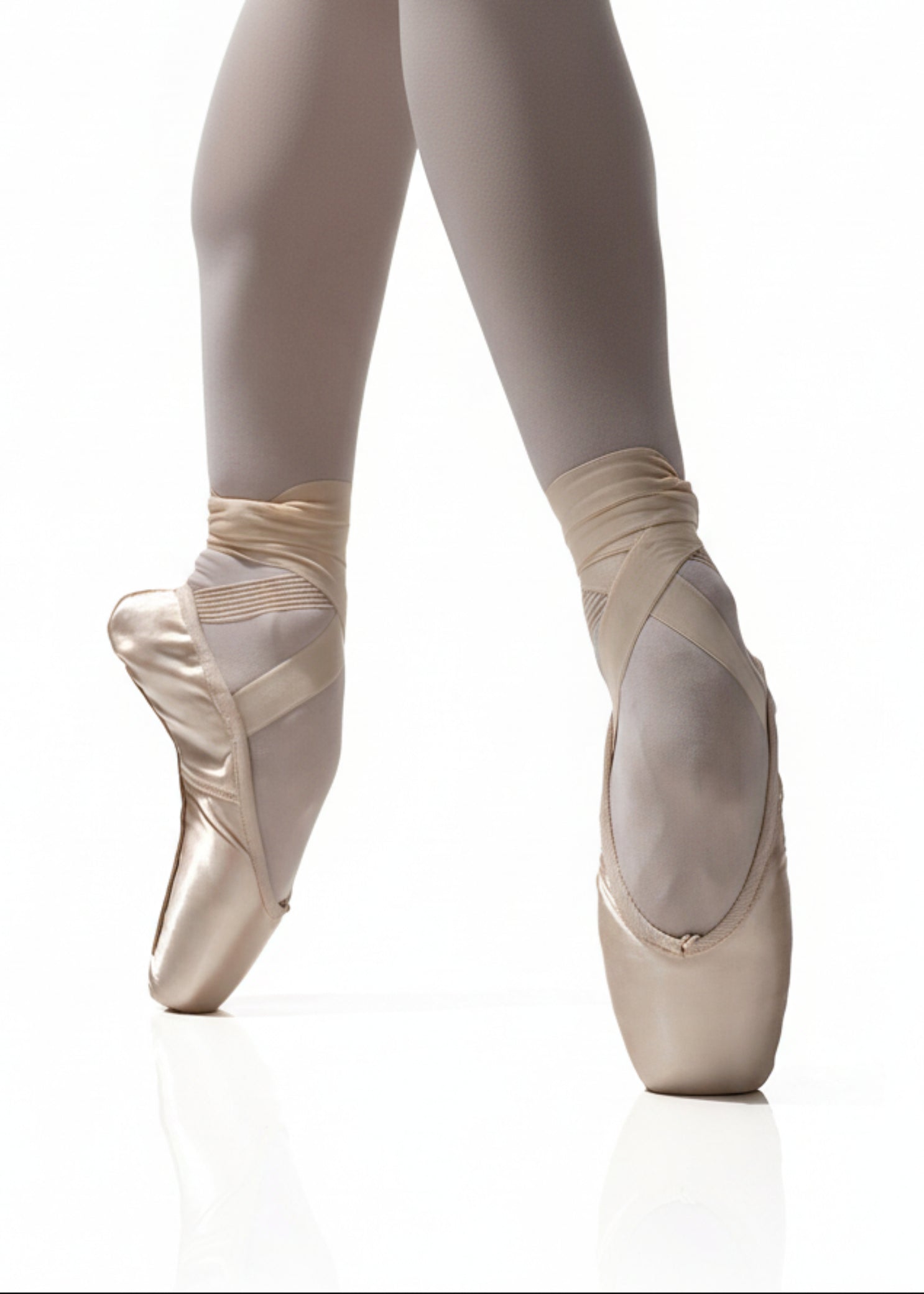 R Class Arpeggia Pointe Shoe Vamp 3 in Pink, lifestyle view showing vamp and platform with ribbon wrap en pointe