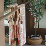 Pippi Post Ballet Fleece Throw Blanket in Pink Ballet Slippers & Florals, lifestyle view showing draped fleece print