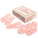Pippi Post Ballet Slippers Card Game, angled view showing pink chipboard slipper pieces beside floral storage box