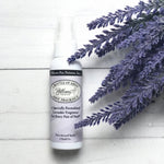 Pillows for Pointes Bottle of Ahhs! Lavender Foot Spray, lifestyle view showing 2 oz bottle beside lavender sprigs