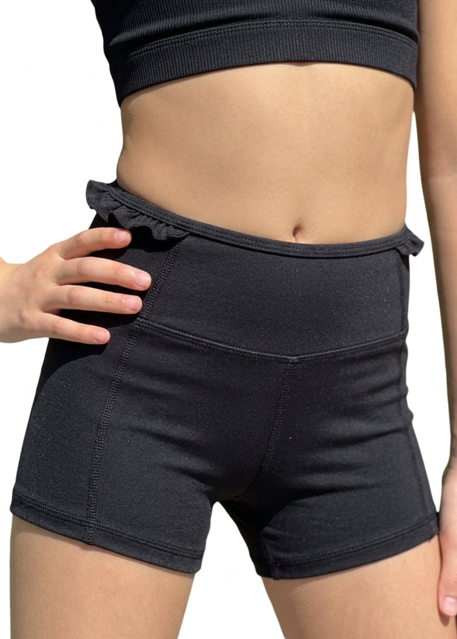 Honeycut Cabana Short in Black, front view showing nylon-spandex fabric, wide waistband and ruffled trim