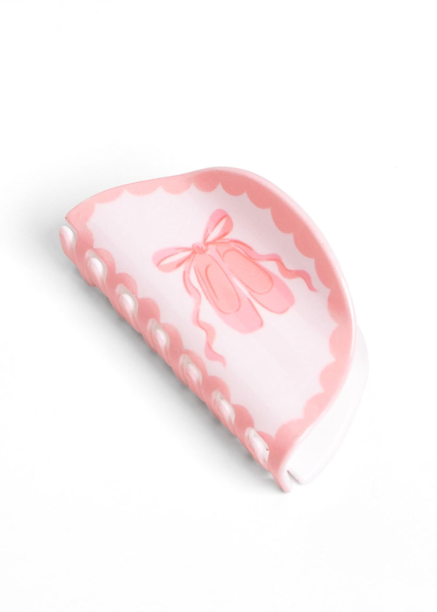 Pippi Post Acrylic Claw Hair Clip Ballet in Pink, detail view showing bow illustration and claw teeth