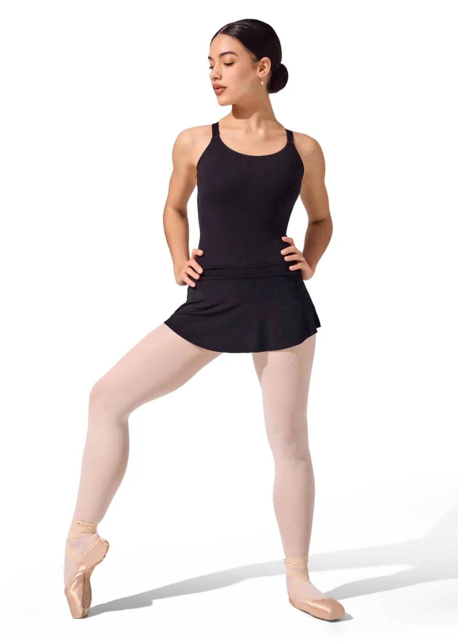 Capezio Curved Pull On Skirt in Black, lifestyle view showing polyester fabric, smooth waistband and curved hem