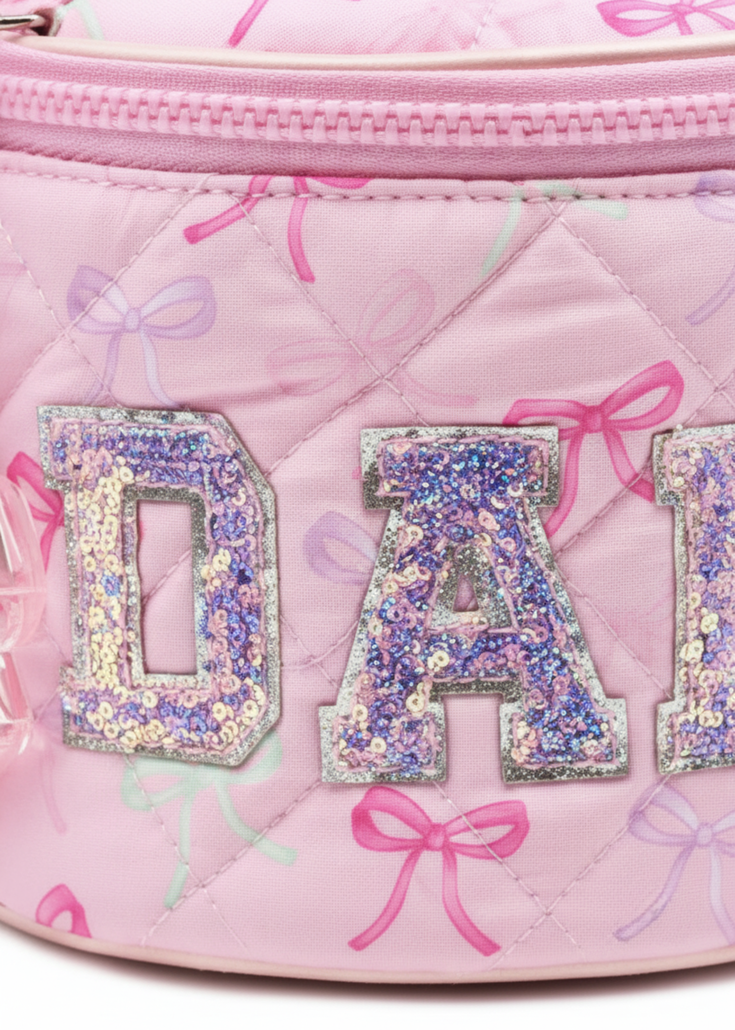 OMG Accessories Makeup Bow Pouch in Pink, detail view showing quilted bow-print exterior and zip closure
