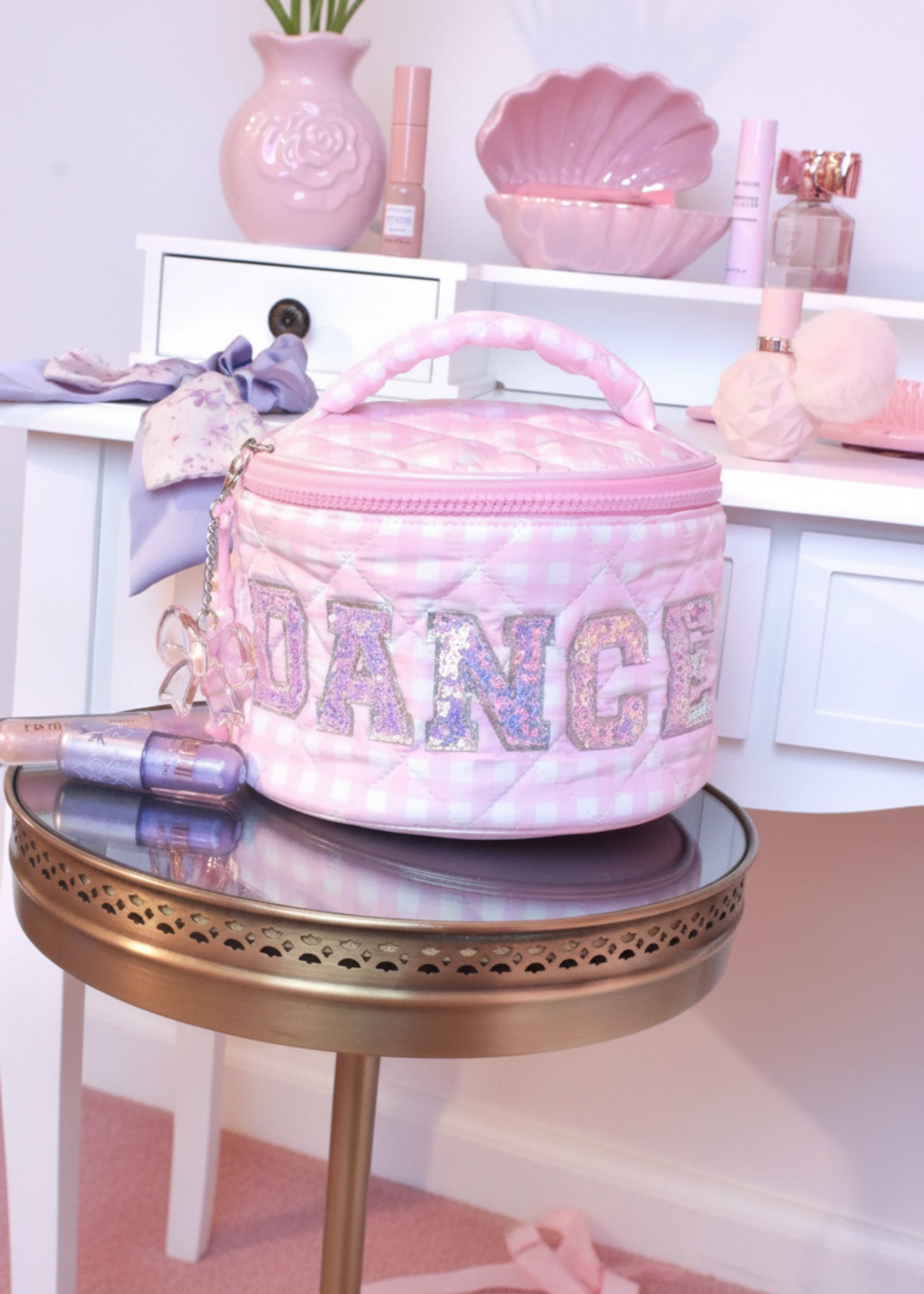 OMG Accessories Dance Gingham Round Glam Bag in Pink, lifestyle view showing gingham exterior and glitter DANCE lettering