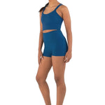 Every Turn Empowered Long Line Crop Top in Dark Ocean, side view showing scoop neckline and long-line fit