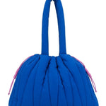 Every Turn Go-Getter Bag in Cobalt, front view showing quilted exterior and pink contrast drawcord closure