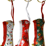 Pillows for Pointes Holiday Mini Pointe Shoe Keychains, collection view showing three festive satin designs