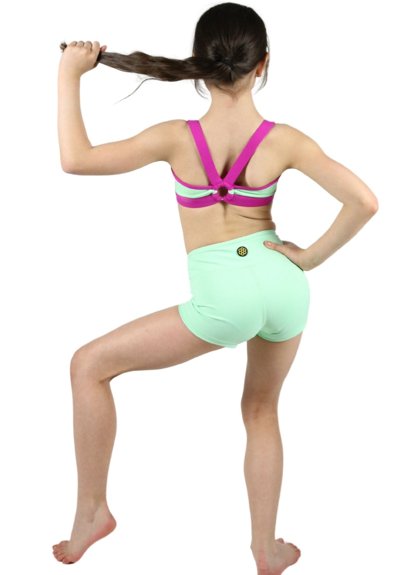 Honeycut Ignite Top in Mint, back view showing geometric X-back straps with contrast color and center ring hardware detail
