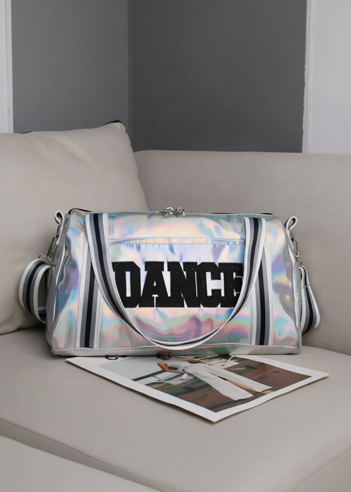 Dasha Designs Iridescent Pro Duffel in Pink and Lavender, lifestyle view showing iridescent exterior and bold DANCE lettering