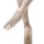 R Class Legata Pointe Shoe Vamp 3 in Pink, lifestyle view showing outsole and platform with ribbon wrap en pointe
