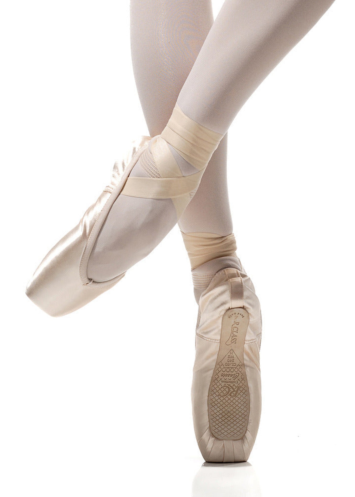 R Class Legata Pointe Shoe Vamp 3 in Pink, lifestyle view showing outsole and platform with ribbon wrap en pointe