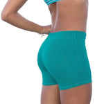 Tiger Friday Low Rider Shorty in Emerald, side view showing fitted shorts with longer inseam and crossover waistband