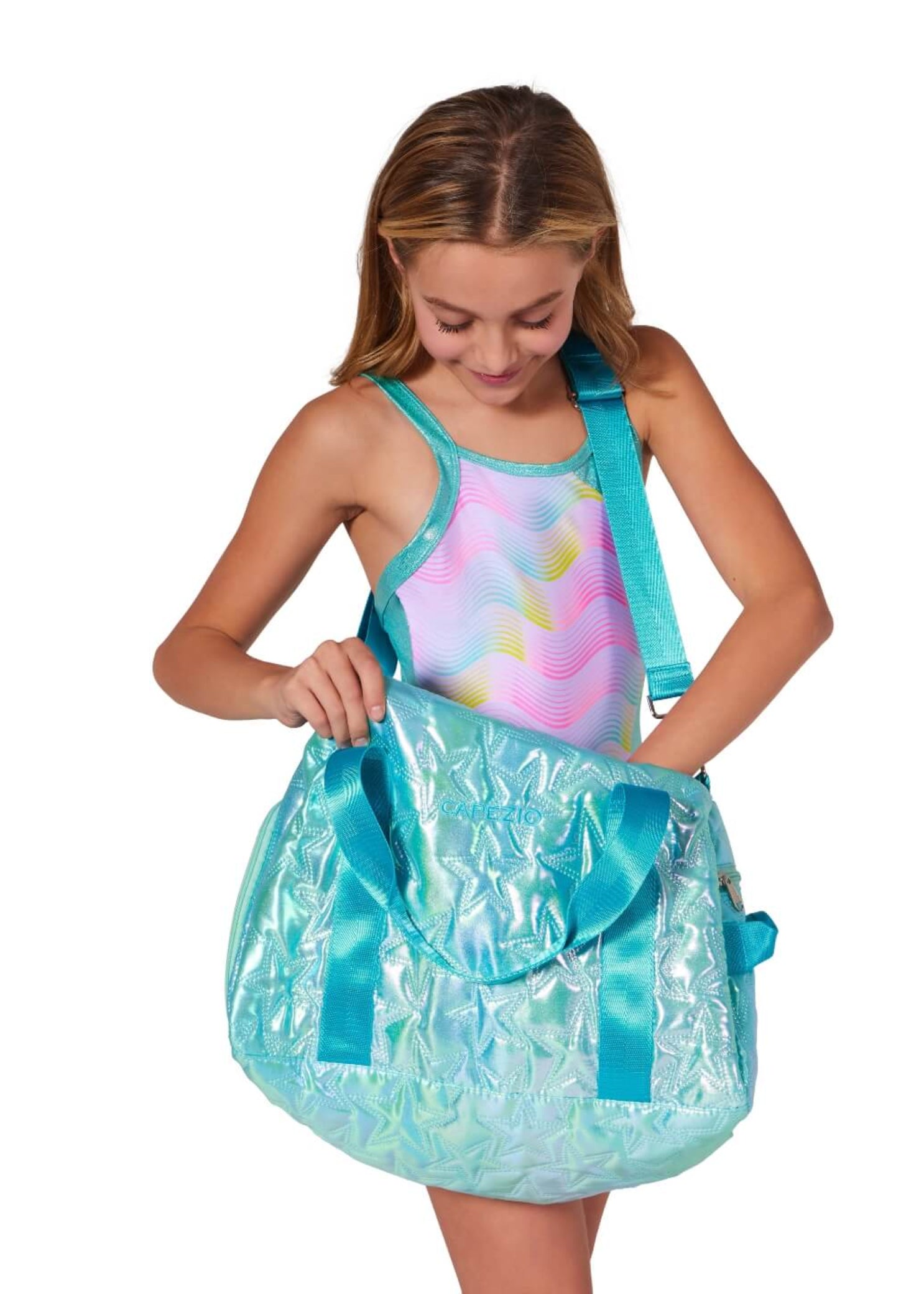 Capezio Metallic Star Duffle in Metallic Turquoise, lifestyle view showing waterproof exterior and shoulder strap