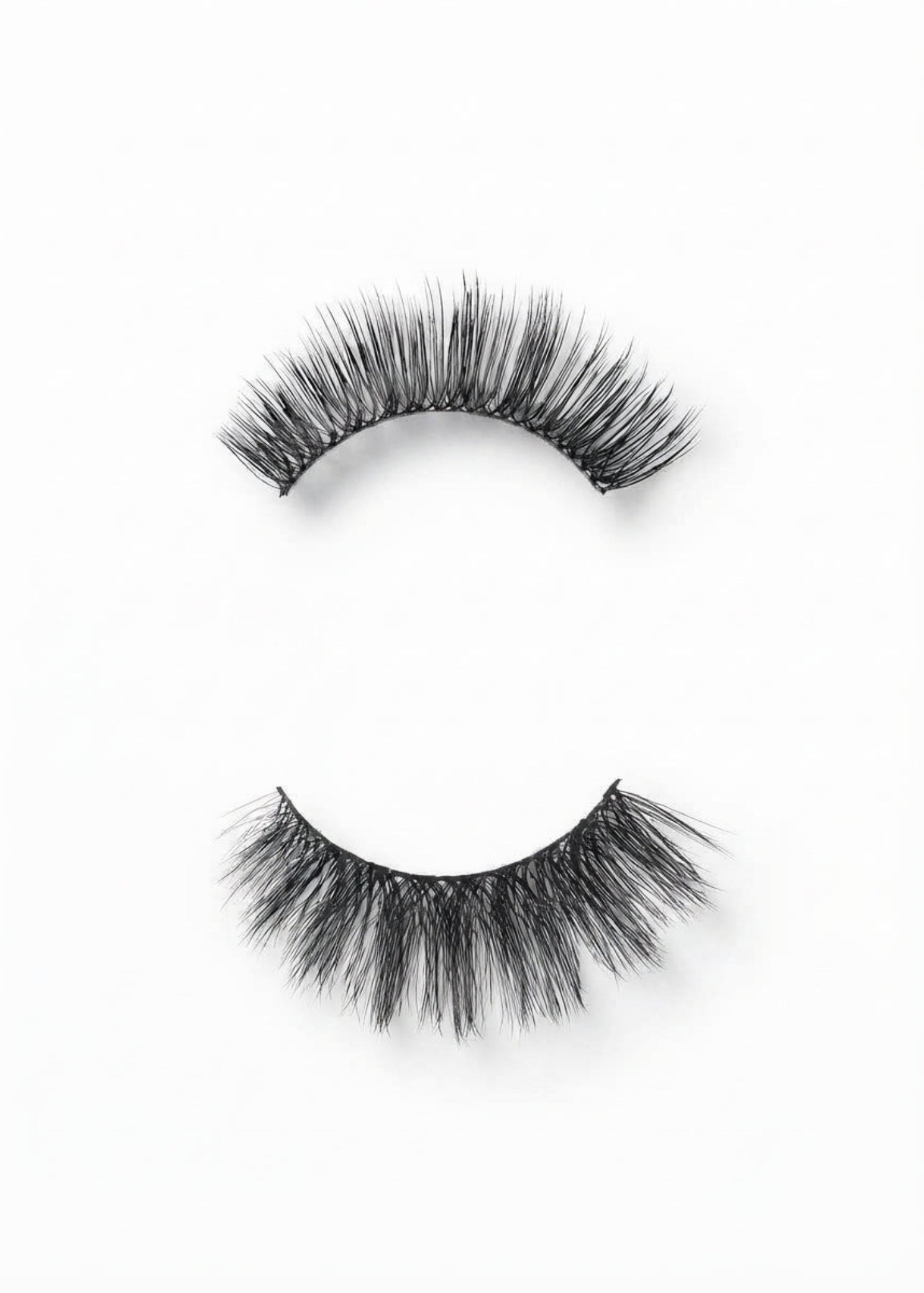 C&J Merchantile Plain Eyelashes, unboxed view showing human hair lash pair with curved bands and layered fibers