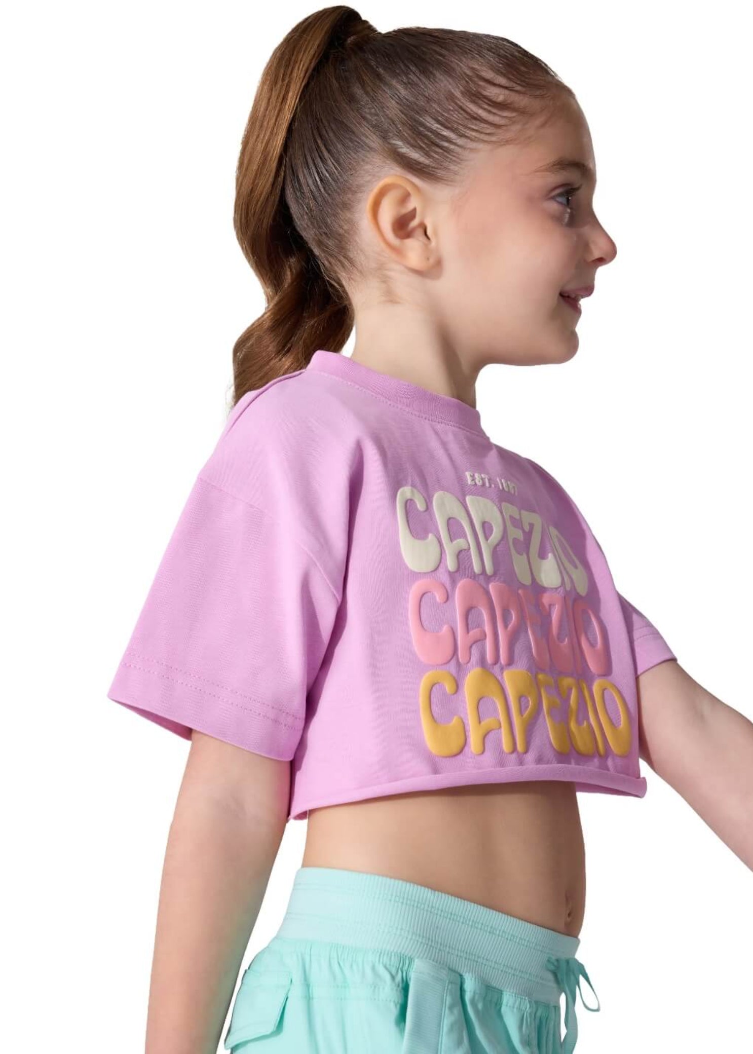 Capezio Retro Box Tee in Orchid, side view showing cotton-blend fabric, cropped hem and stacked Capezio lettering