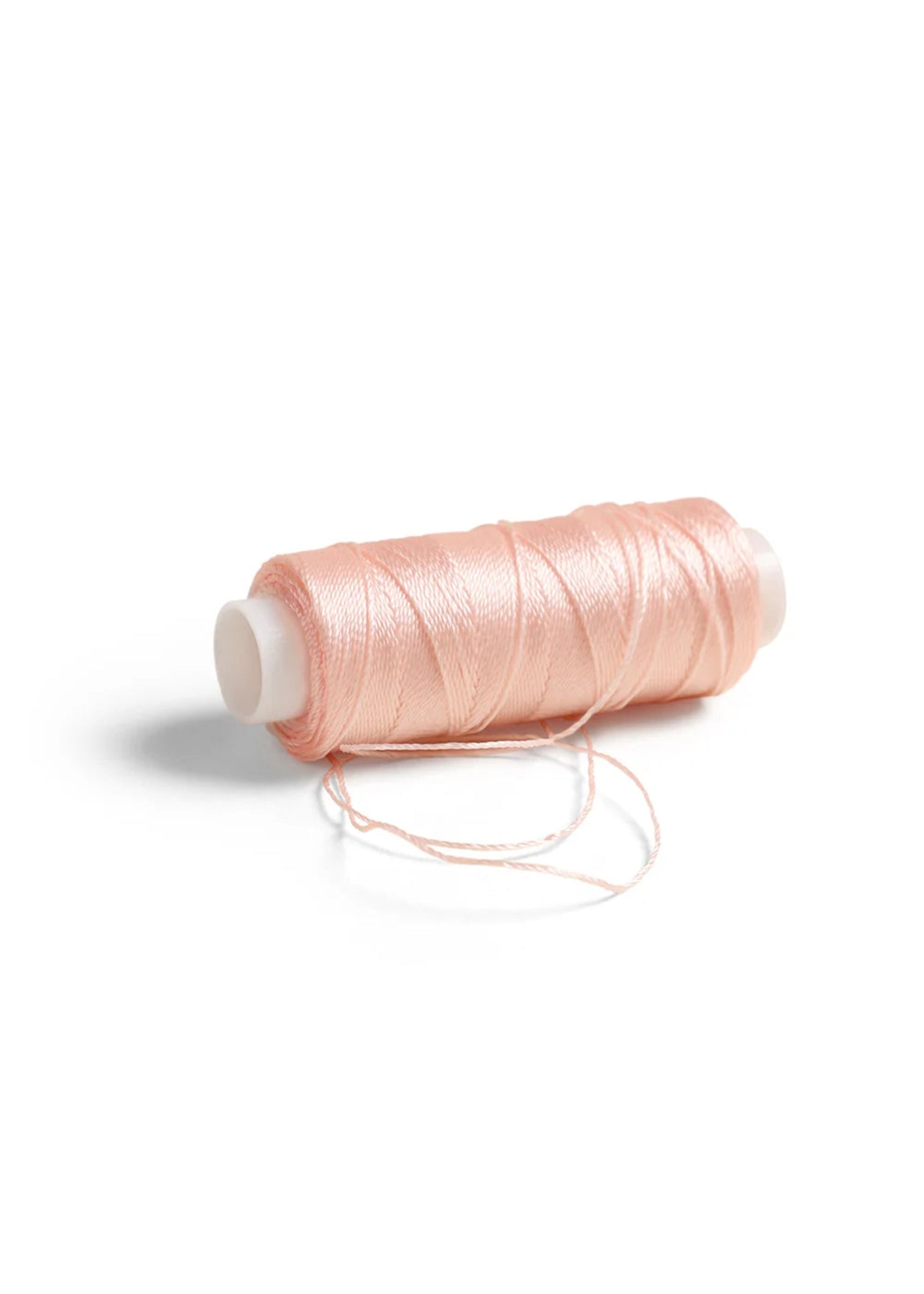 RP Collection Sewing Thread in Pink, detail view showing wax-coated thread and loose strand