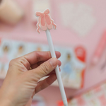 Pippi Post Slippers & Bow Gel Pen, lifestyle view showing ballet slipper and bow topper with exposed writing tip