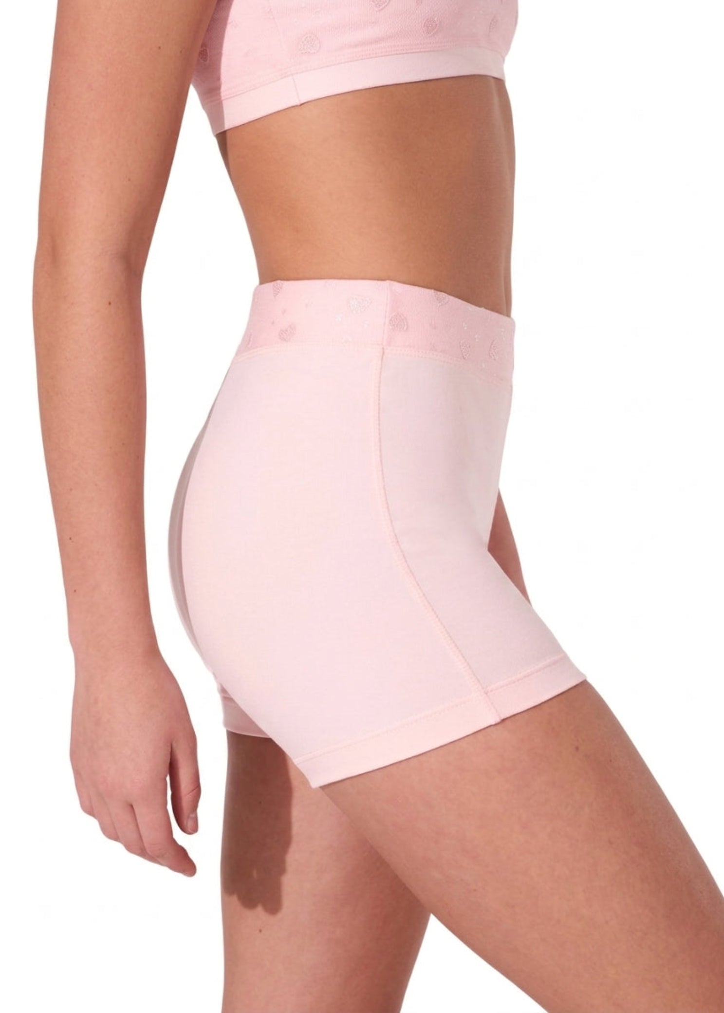 Capezio Sweet Hearts Short in Pink, side view showing nylon-spandex fabric, heart mesh waistband and fitted cut