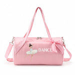 Dasha Designs glossy pink barrel duffel, front view showing ballerina graphic, DANCE lettering, satin bow, and adjustable strap