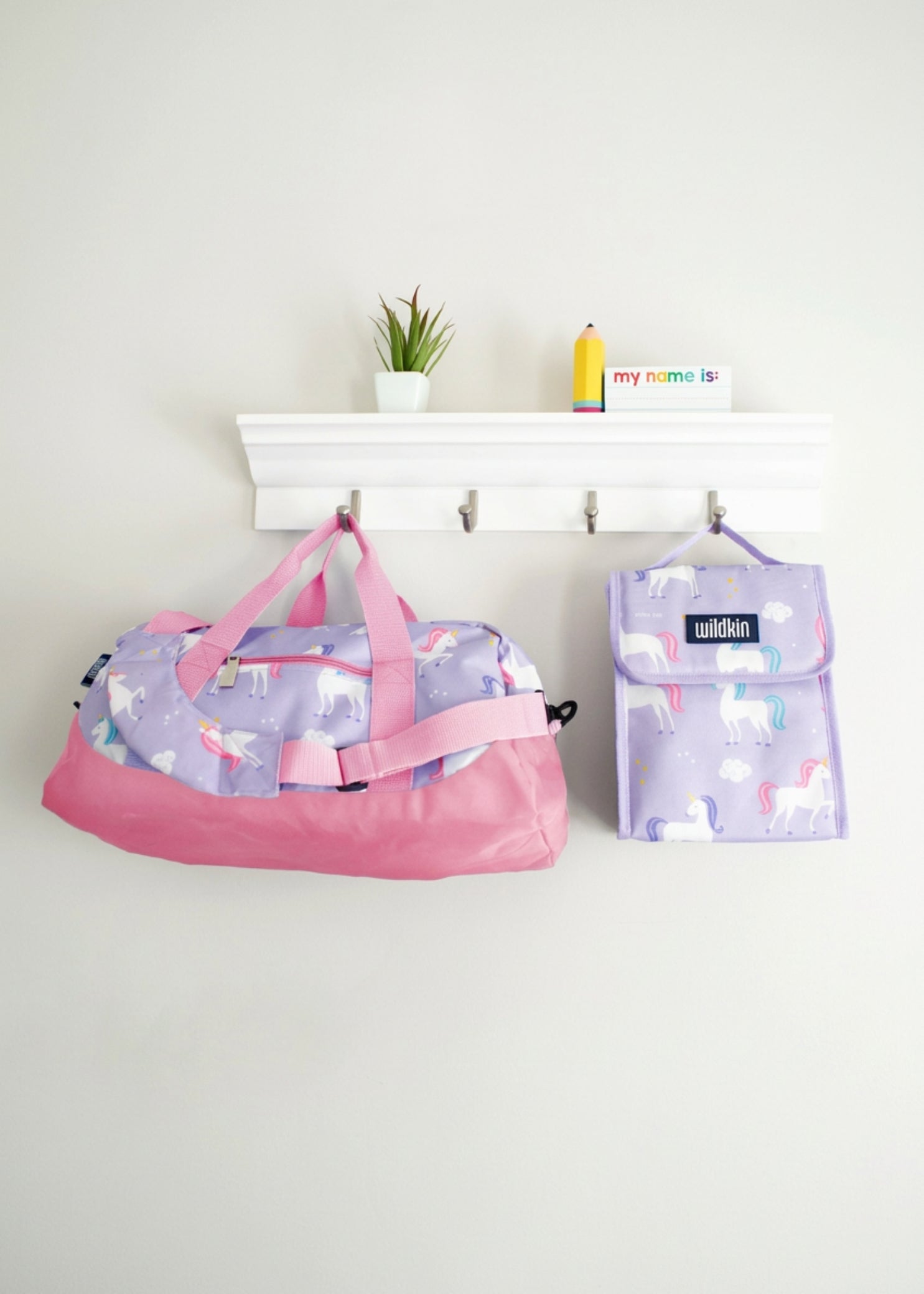 Wildkin Polyester Unicorn Overnighter Duffel in Purple, lifestyle view showing unicorn print and carry handles