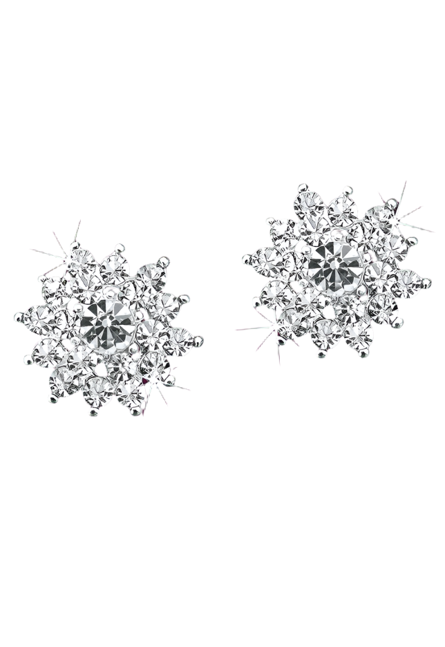 Pair of snowflake-shaped silver earrings with clear gemstones on a purple background