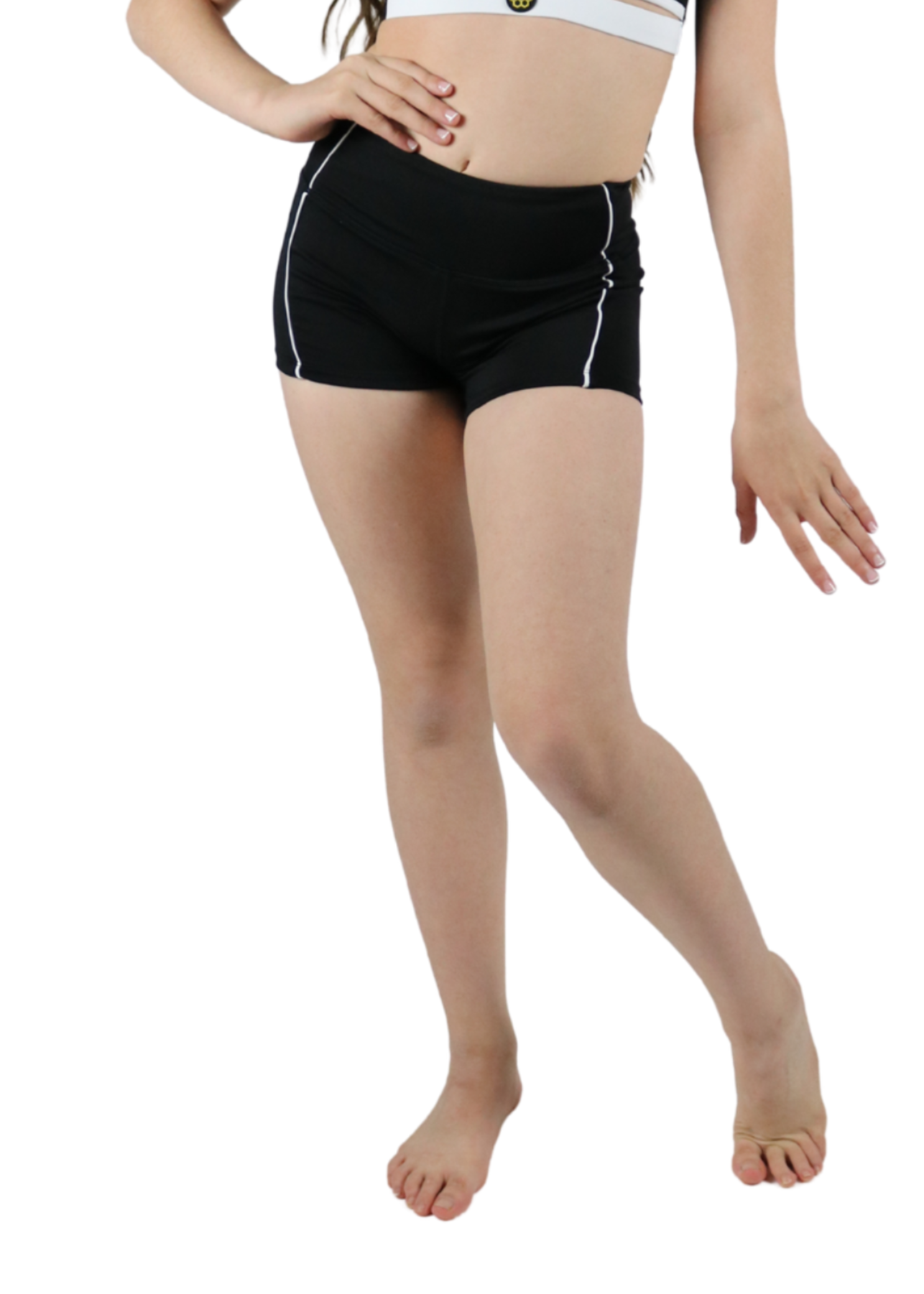 Young girl wearing a black and white sports outfit on a white background