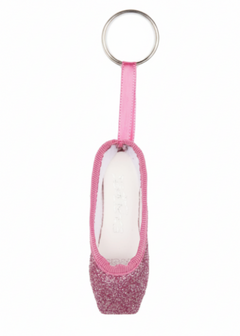 So Danca glitter mini pointe shoe keychain in Rose, side view showing light pink glitter body, matching pink ribbon strap, white interior lining, and silver split key ring