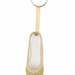 Gold mini pointe shoe keychain with glitter accents and lightweight design